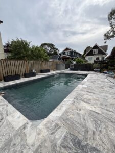 Silver Travertine Pavers on a pool deck in Victoria, BC